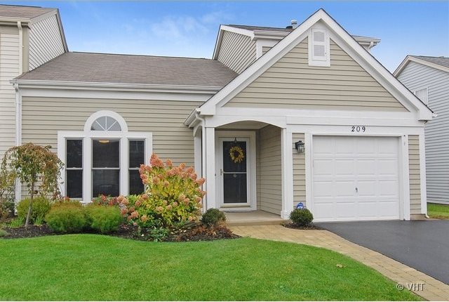 view of front facade with a front yard and a garage