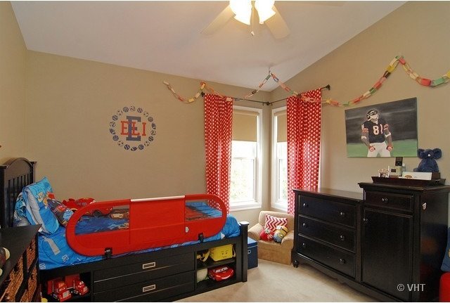 carpeted bedroom with ceiling fan and lofted ceiling