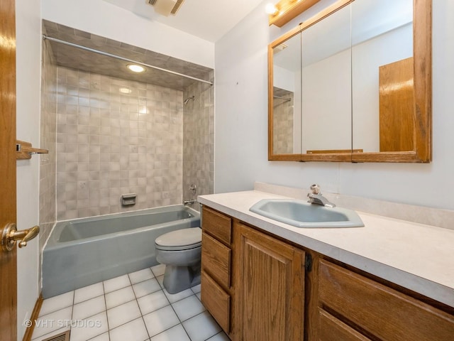 full bathroom with toilet, tiled shower / bath combo, tile patterned floors, and vanity