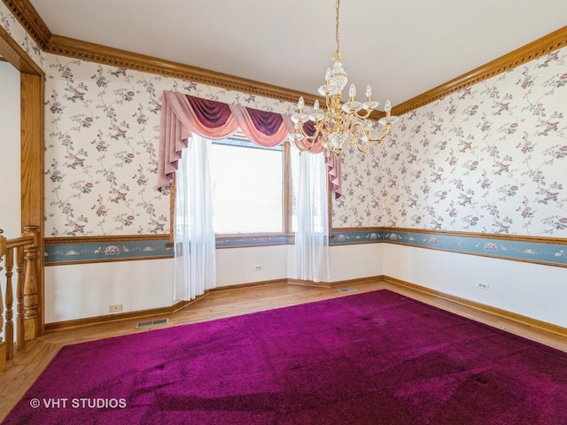 empty room with wood-type flooring and ornamental molding