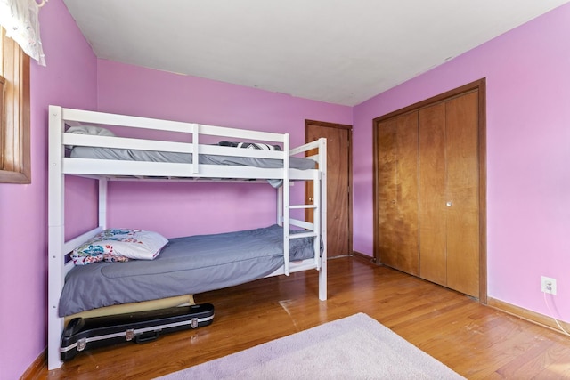 bedroom featuring hardwood / wood-style flooring and a closet