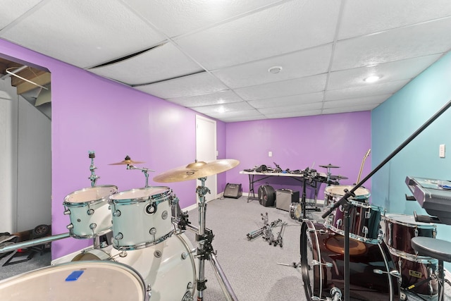 rec room featuring a paneled ceiling and carpet flooring