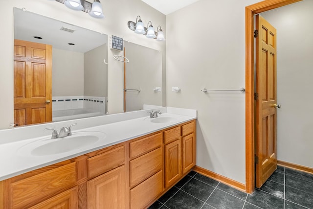 bathroom with tile patterned flooring, vanity, and a bathtub