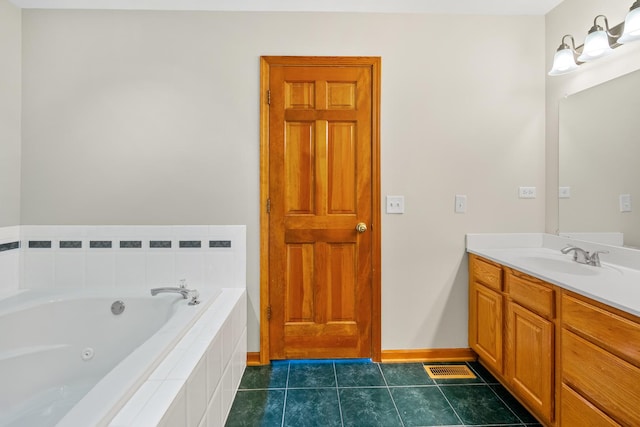 bathroom featuring tiled tub, tile patterned flooring, and vanity