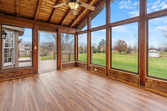 unfurnished sunroom with vaulted ceiling with beams, ceiling fan, and wood ceiling