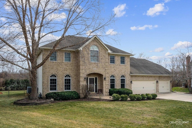 colonial-style house with a front yard and a garage