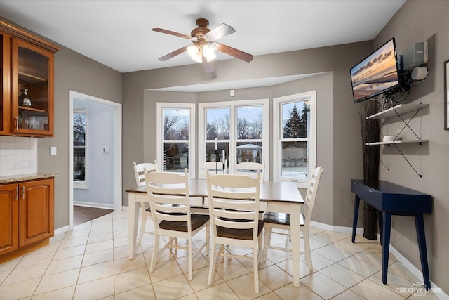 tiled dining room with ceiling fan