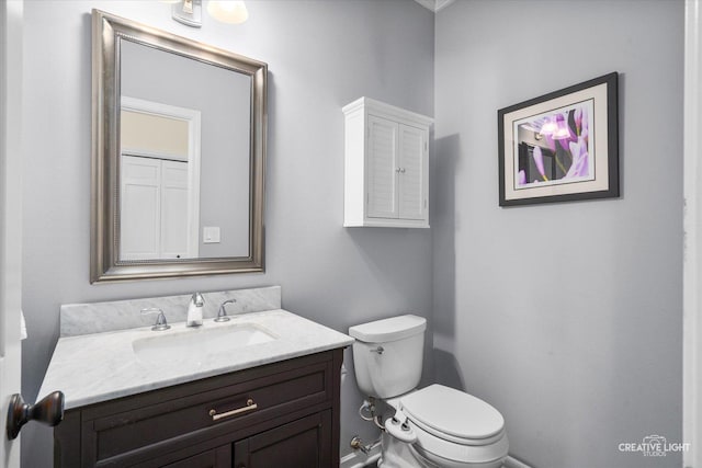 bathroom featuring toilet and vanity