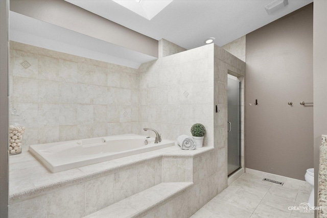 bathroom with plus walk in shower, tile patterned floors, and toilet