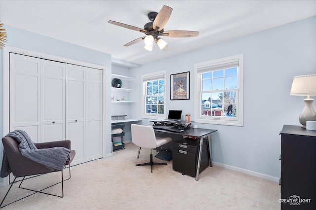 home office with ceiling fan, light colored carpet, and a textured ceiling