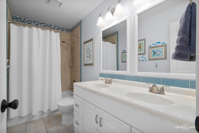 full bathroom with toilet, a textured ceiling, shower / bath combo with shower curtain, tasteful backsplash, and vanity