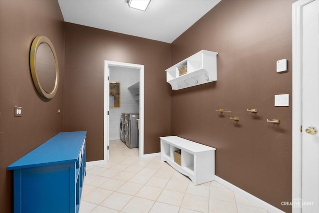 mudroom featuring light tile patterned floors and washer and clothes dryer