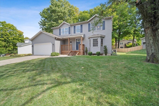 view of front of house featuring a garage, a front yard, and central AC