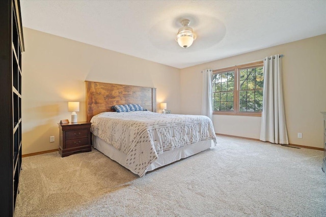 bedroom featuring ceiling fan and light carpet