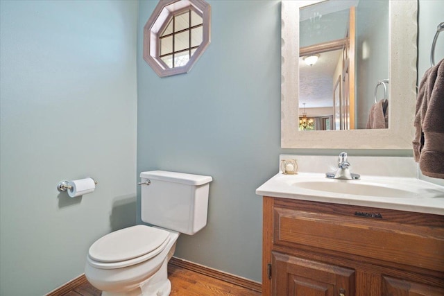 bathroom featuring vanity, toilet, and wood-type flooring