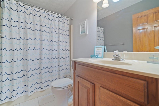 bathroom featuring tile patterned floors, a shower with curtain, vanity, a textured ceiling, and toilet