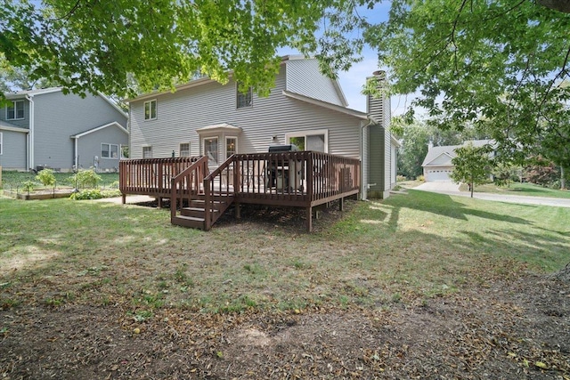 rear view of house featuring a yard and a deck