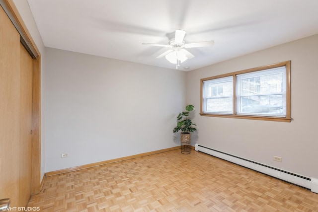 unfurnished bedroom featuring ceiling fan, light parquet floors, and a baseboard heating unit