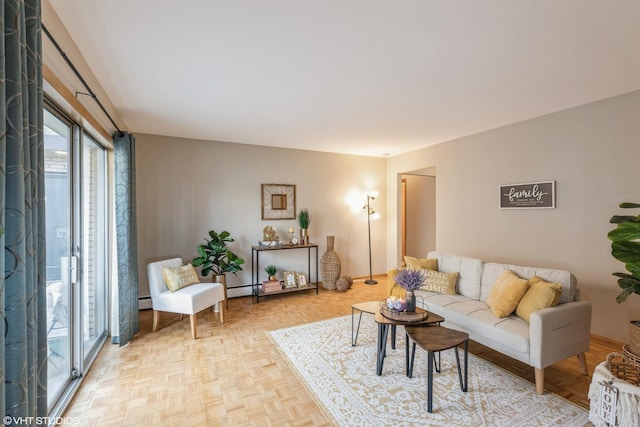 living room with a baseboard radiator and light parquet flooring