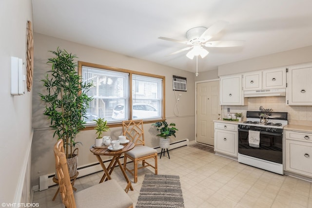 kitchen with tasteful backsplash, gas range gas stove, white cabinets, and ceiling fan