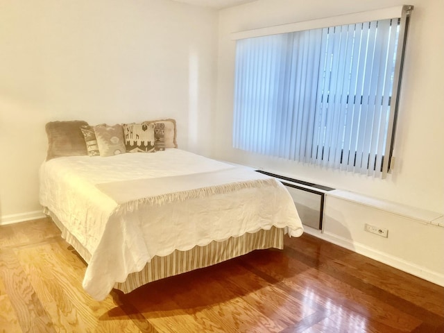 bedroom with hardwood / wood-style flooring