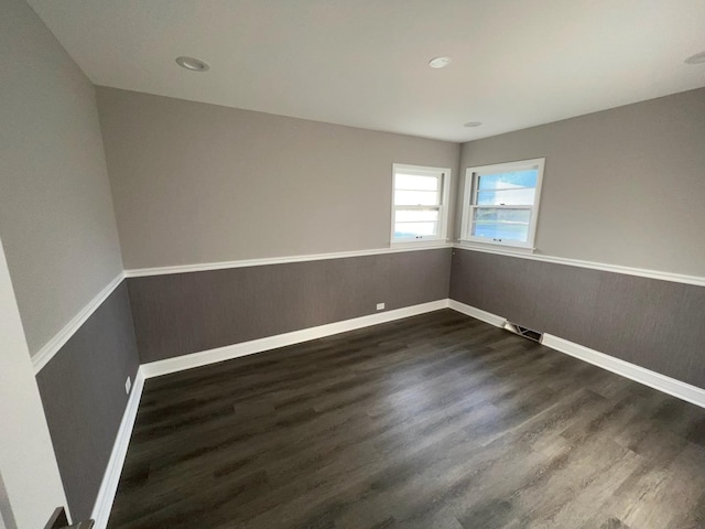 spare room featuring dark hardwood / wood-style flooring