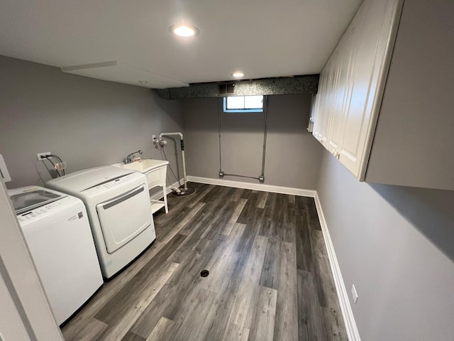 laundry room featuring dark hardwood / wood-style flooring, independent washer and dryer, and sink