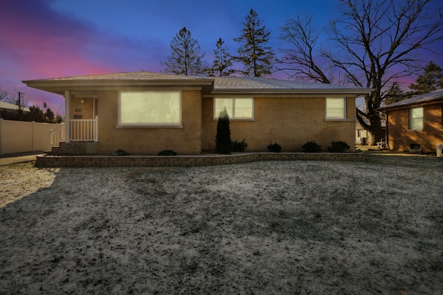 view of back house at dusk