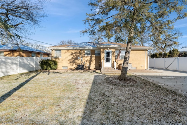 back of house with a yard and a patio