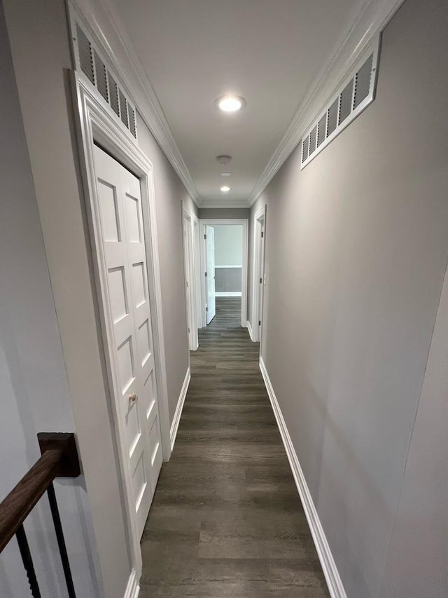 hallway with dark hardwood / wood-style floors and ornamental molding