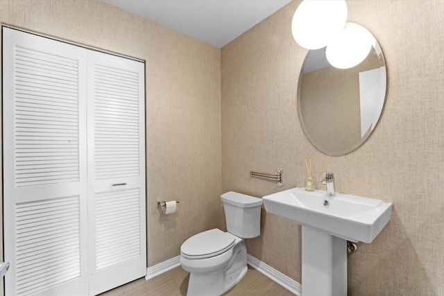 bathroom featuring hardwood / wood-style floors and toilet