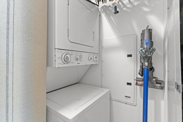 laundry room featuring stacked washer / drying machine