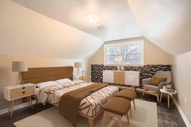 bedroom with dark hardwood / wood-style floors and lofted ceiling