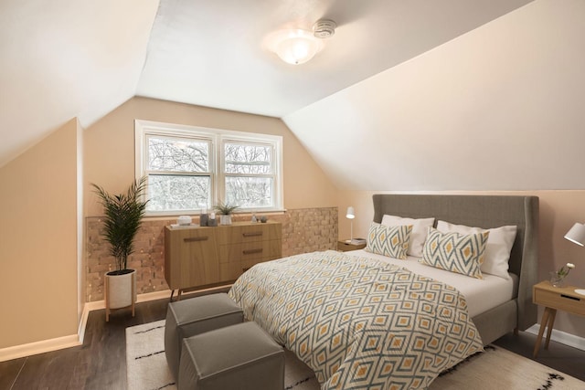 bedroom featuring dark wood-type flooring and vaulted ceiling