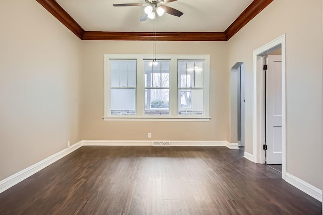 empty room featuring ceiling fan, dark hardwood / wood-style flooring, and ornamental molding