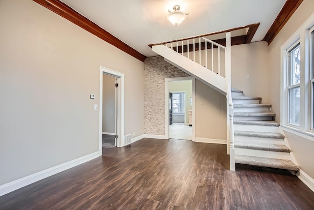 interior space featuring wood-type flooring, ornamental molding, and a wealth of natural light