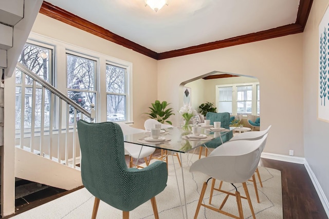 dining area featuring ornamental molding and hardwood / wood-style flooring