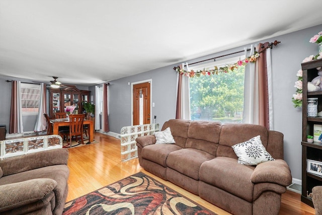 living room featuring hardwood / wood-style floors, plenty of natural light, and ceiling fan