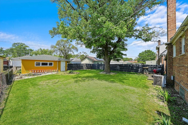 view of yard featuring an outbuilding and central AC