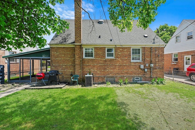 back of property featuring a lawn, a sunroom, and central AC unit