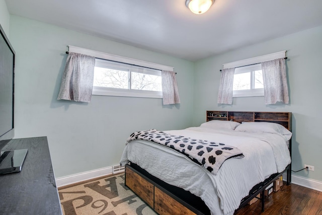 bedroom with dark hardwood / wood-style flooring