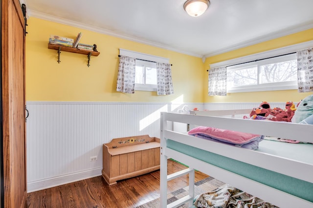 bedroom with ornamental molding and wood-type flooring