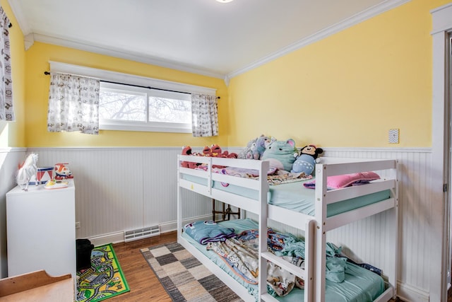 bedroom with dark wood-type flooring and ornamental molding