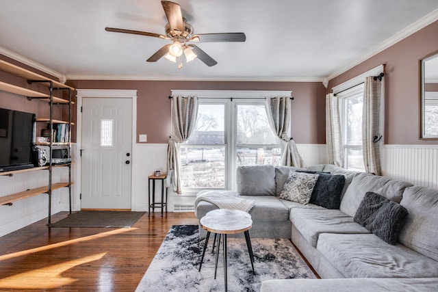 living room with ceiling fan, ornamental molding, and dark hardwood / wood-style floors