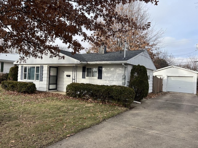 single story home featuring an outbuilding, a front lawn, and a garage