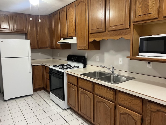 kitchen with light tile patterned flooring, white appliances, and sink