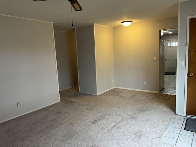 carpeted spare room featuring ceiling fan