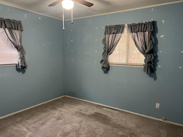 carpeted spare room with ceiling fan and ornamental molding