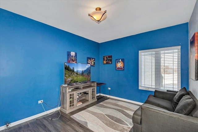 living room with wood finished floors and baseboards