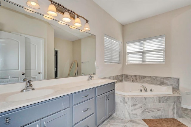 full bathroom with marble finish floor, a sink, a whirlpool tub, and double vanity